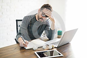 Frustrated and stressed male book writer photo