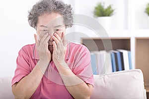 Frustrated stressed senior older grandmother suffering from blurred eyesight, eyes strain pain ache