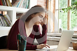 Frustrated stressed woman worried about work problem looking at