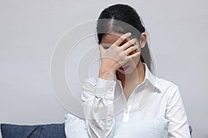 Frustrated stressed young Asian business woman with hands on face tired from work.