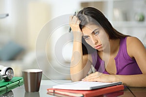 Frustrated student complaining at home trying to memorize lesson photo
