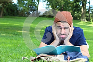 Frustrated student with his notebook on campus