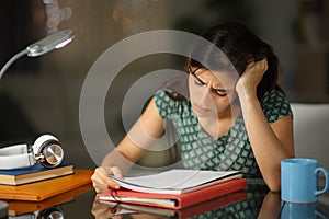 Frustrated student in the night trying to memorize photo