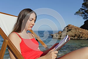 Frustrated student studying on the beach on vacation
