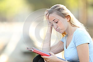 Frustrated student trying to learn lesson reading notes