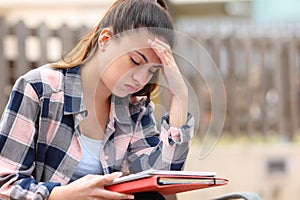 Frustrated student trying to understand lesson in a park