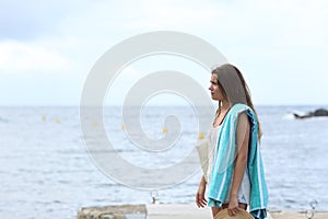 Frustrated sunbather on the beach in a cloudy day