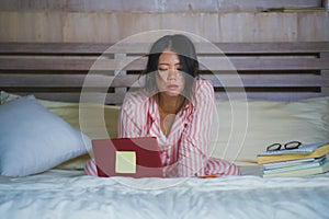 Frustrated and tired Asian Korean university student woman feeling overwhelmed and stressed preparing exam studying with laptop