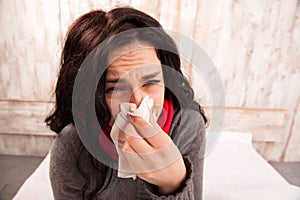 Frustrated woman blowing her nose
