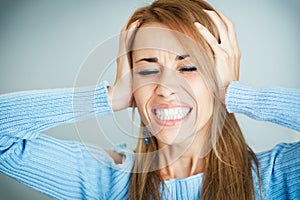 Frustrated woman covering ears with hands