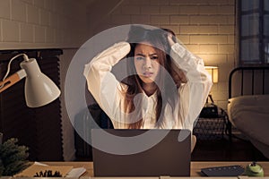 frustrated woman facing challenges while working late at home