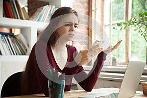 Annoyed frustrated woman having problem with not working mobile photo
