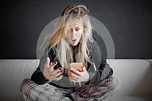 Frustrated woman looking at her phone