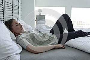 Frustrated woman lying on bedstead