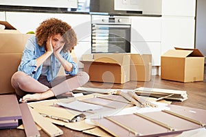 Frustrated Woman Putting Together Self Assembly Furniture