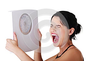 Frustrated woman with scale