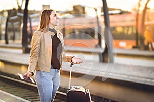 Frustrated woman at train station. Late, delayed, canceled.