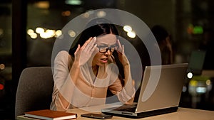 Frustrated woman working laptop, nervous about mistakes, stressful job, problem