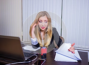 Frustrated worried young woman looks at laptop upset by bad news, teenager feels shocked afraid reading negative bullying message,