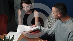 Frustrated young adult man and woman feeling stressed about doing paperwork at home or office. Angry man having