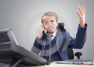 Frustrated young child businessman despair and disappointment on the telephone