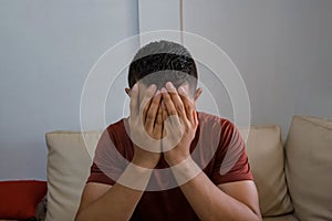 Frustrated young man crying in the bedroom, copying space