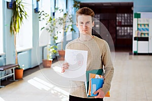 Frustrated young student with bad test result showing paper to the camera