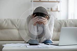 Frustrated young woman feeling stressed about financial problems.