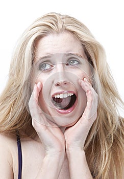 Frustrated young woman screaming against white background