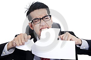 Frustration businessman tearing documents