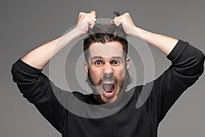 Frustration, man tearing hair out in anger