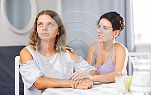 Frustration woman sitting at home and her partner asking to forgive after argument