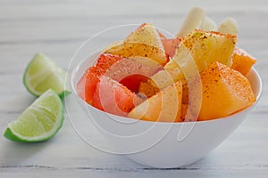 Fruta con chile, mexican snack Bowl of healthy fresh fruit salad photo