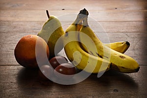 photo of a bunch of bananas peaches plums natural fruits photo