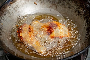 Fry the chicken in a pan with boiling oil