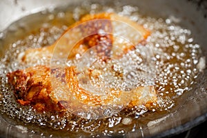 Fry the chicken in a pan with boiling oil