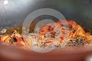 Fry the chicken in a pan with boiling oil,soft focus