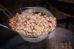 Fry the pork skin in a large frying pan on the stove