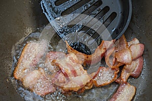Frying bacon in the pan.