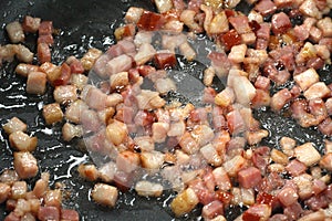 Frying bacon to make greaves.