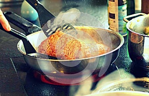 Frying a beef steak in a pan