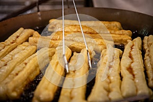 Frying Chinese Donut Sticks - youtiao