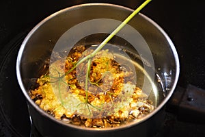 Frying elderflower in pancake batter in a small pot of boiling o