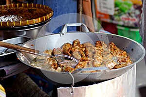 Frying Fish Cakes Tod Man Pla in big pan.Street food in local market