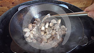 Frying of meat in a kazan on a gas grill