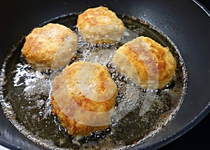 Frying a minced meat steaks covered in crispy breadcrumb