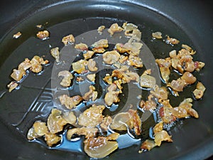 Crispy bacon fat in an oily pan