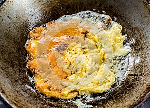 Frying omelet in pan