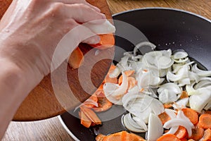 Frying onion and carrot on pan with spatula,  ingredient