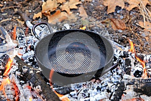 Frying pan on embers